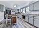 Galley kitchen with gray cabinets, granite countertops, and wood island at 198 Oak Hill Cir, Canton, GA 30114