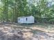 White storage shed in a wooded backyard setting at 198 Oak Hill Cir, Canton, GA 30114