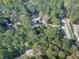 Aerial view showing a house nestled in a wooded area with a long driveway at 198 Oak Hill Cir, Canton, GA 30114