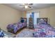 Cozy bedroom with twin beds, ample closet space, and a ceiling fan at 1896 Alcovy Bluff Way, Lawrenceville, GA 30045