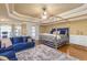 Large main bedroom with a plush carpet, a king-size bed, and a seating area at 1896 Alcovy Bluff Way, Lawrenceville, GA 30045