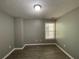Bright bedroom with gray walls, hardwood floors, and window at 2095 Manhattan Pkwy, Decatur, GA 30035