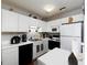 Well-equipped kitchen featuring white cabinets, black appliances, and ample counter space at 253 Gallant Se # 17, Mableton, GA 30126