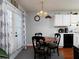 Cozy dining area with a round table and four chairs near kitchen at 253 Gallant Se # 17, Mableton, GA 30126