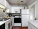 White kitchen cabinets, black appliances and a view into hallway at 253 Gallant Se # 17, Mableton, GA 30126