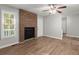 Living room with brick fireplace and wood-look floors at 3512 Collier Nw Dr, Atlanta, GA 30331