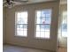 Living room with large windows and ceiling fan at 6348 Wellington Walk Way, Lithonia, GA 30058