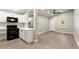 Modern kitchen with white cabinets, black appliances, and a breakfast bar at 2396 Abner Nw Pl, Atlanta, GA 30318
