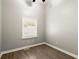 Well-lit bedroom featuring a window, ceiling fan, and wood-look floors at 2396 Abner Nw Pl, Atlanta, GA 30318