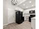 Modern kitchen with white shaker cabinets, quartz counters, and black appliances at 2396 Abner Nw Pl, Atlanta, GA 30318