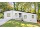 Charming ranch home with a white exterior, deck, and landscaped yard at 2396 Abner Nw Pl, Atlanta, GA 30318
