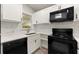 Well-appointed kitchen featuring white cabinets and black appliances at 2396 Abner Nw Pl, Atlanta, GA 30318