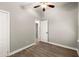 Spacious bedroom with wood-look floors, a ceiling fan and access to another room at 2396 Abner Nw Pl, Atlanta, GA 30318