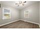 Bright bedroom with two windows, ceiling fan, and wood-look flooring at 2396 Abner Nw Pl, Atlanta, GA 30318