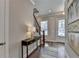 Entryway with hardwood floors, console table, and stairs at 4627 Molder Dr, Buford, GA 30518
