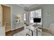 Spacious home office with hardwood floors, a large window, and an adjacent bathroom at 4627 Molder Dr, Buford, GA 30518