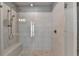 Large walk-in shower with glass enclosure and built-in seat at 4627 Molder Dr, Buford, GA 30518