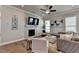 Living area with sectional sofa, fireplace, and hardwood floors at 4627 Molder Dr, Buford, GA 30518