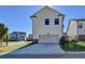 House rear elevation showcasing a two-car garage with a driveway and fenced yard at 4627 Molder Dr, Buford, GA 30518