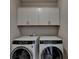 Laundry room with upper cabinets and a washer and dryer at 4627 Molder Dr, Buford, GA 30518