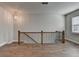 Spacious loft area with hardwood floors and an open staircase at 4627 Molder Dr, Buford, GA 30518