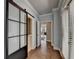 Light-filled hallway with hardwood floors and barn door at 4627 Molder Dr, Buford, GA 30518