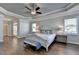 Bright main bedroom with hardwood floors, a ceiling fan, and large windows at 4627 Molder Dr, Buford, GA 30518