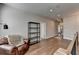Relaxing loft area featuring hardwood floors, a comfortable chair, and a stylish bookshelf at 4627 Molder Dr, Buford, GA 30518