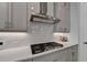 Modern gas cooktop with stainless steel range hood at 4627 Molder Dr, Buford, GA 30518