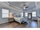Large main bedroom with hardwood floors, tray ceiling, and ensuite bathroom at 4627 Molder Dr, Buford, GA 30518