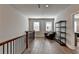 Open loft area with hardwood floors, a seating area, and built-in shelving at 4627 Molder Dr, Buford, GA 30518