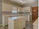 Kitchen with island and view to Gathering room at 2404 Lake Cove Ct, Lithonia, GA 30058