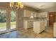 Kitchen with island, white cabinets, and backyard access at 2404 Lake Cove Ct, Lithonia, GA 30058
