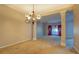 Spacious dining room with chandelier and neutral color palette at 2404 Lake Cove Ct, Lithonia, GA 30058