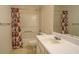 Bathroom with floral shower curtain and vanity at 2404 Lake Cove Ct, Lithonia, GA 30058