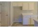 White kitchen cabinets and tile floor at 2404 Lake Cove Ct, Lithonia, GA 30058