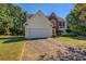 Two-story house with a white garage door at 2404 Lake Cove Ct, Lithonia, GA 30058