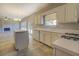 Kitchen features island, white cabinets, and tile floors at 2404 Lake Cove Ct, Lithonia, GA 30058