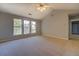 Spacious bedroom with three windows and a ceiling fan at 2404 Lake Cove Ct, Lithonia, GA 30058