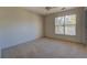 Spacious bedroom with carpet and large window at 2404 Lake Cove Ct, Lithonia, GA 30058