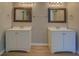 Double vanity bathroom with updated light fixtures and mirrors at 2404 Lake Cove Ct, Lithonia, GA 30058