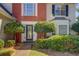 House entrance with brick, bushes, and a black door at 2404 Lake Cove Ct, Lithonia, GA 30058