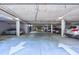 Underground parking garage with designated parking spaces and clear signage at 2300 Peachford Rd # 1205, Dunwoody, GA 30338
