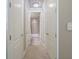 Long hallway with multiple doors and carpet flooring at 2300 Peachford Rd # 1205, Dunwoody, GA 30338