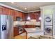 Modern kitchen with granite countertops, stainless steel appliances, and laundry closet at 2300 Peachford Rd # 1205, Dunwoody, GA 30338