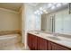 Bathroom with a large garden tub and double vanity at 2300 Peachford Rd # 1205, Dunwoody, GA 30338
