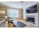 Comfortable living room with fireplace and large TV at 2300 Peachford Rd # 1205, Dunwoody, GA 30338