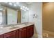 Double vanity bathroom with a large mirror and a walk-in shower at 2300 Peachford Rd # 1205, Dunwoody, GA 30338