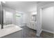 Bathroom with white vanity, marble shower, and grey floor at 118 Briargate Dr, Johns Creek, GA 30097