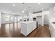 Open concept kitchen with island and hardwood floors at 118 Briargate Dr, Johns Creek, GA 30097